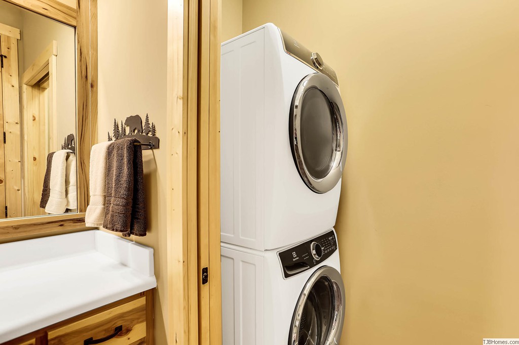 Stackable washer dryer hidden with pocket door