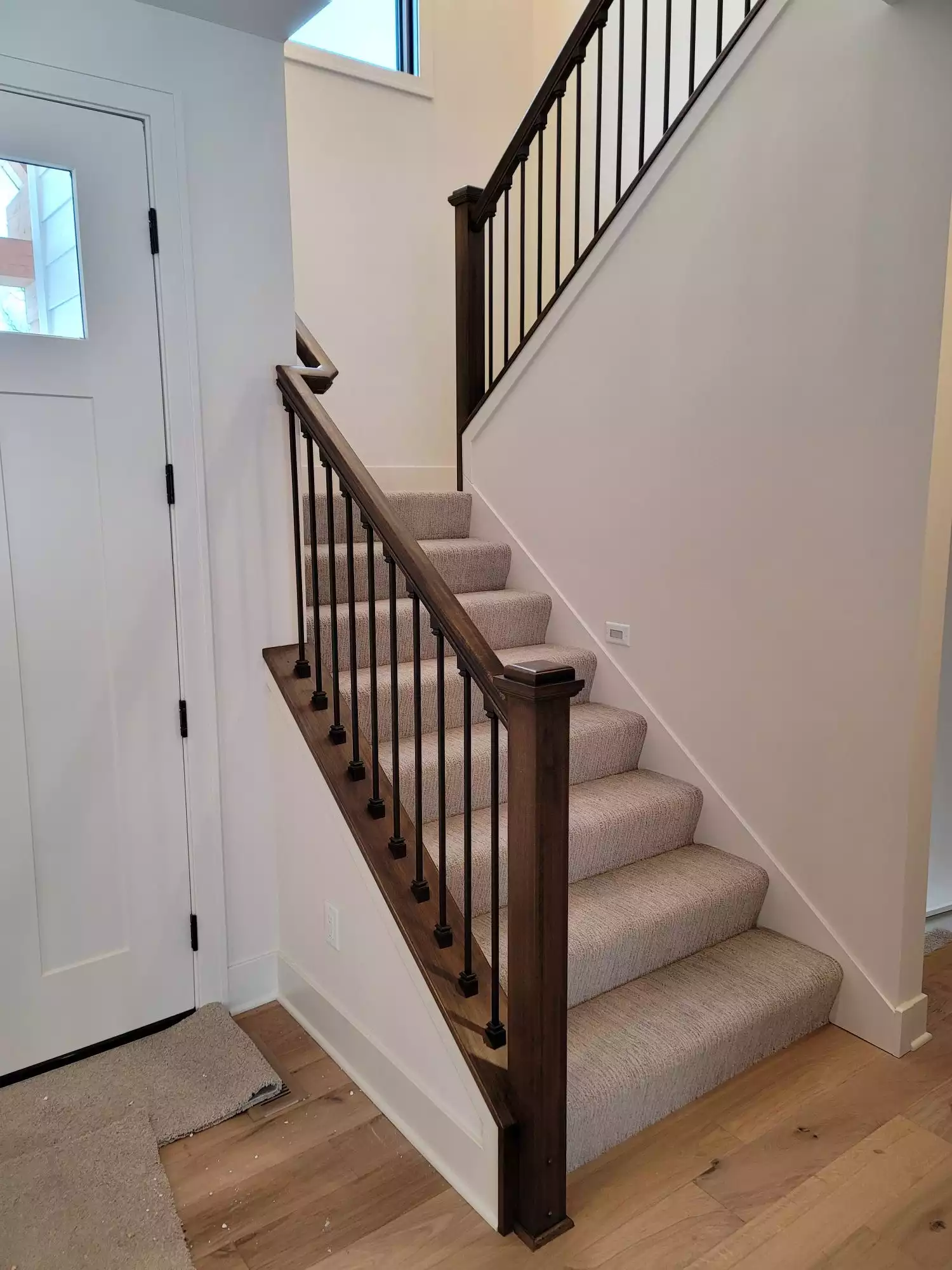 Wood baluster and wrought iron spindles of open staircase