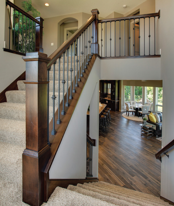 An angled corner staircase leads to the second-floor bedrooms