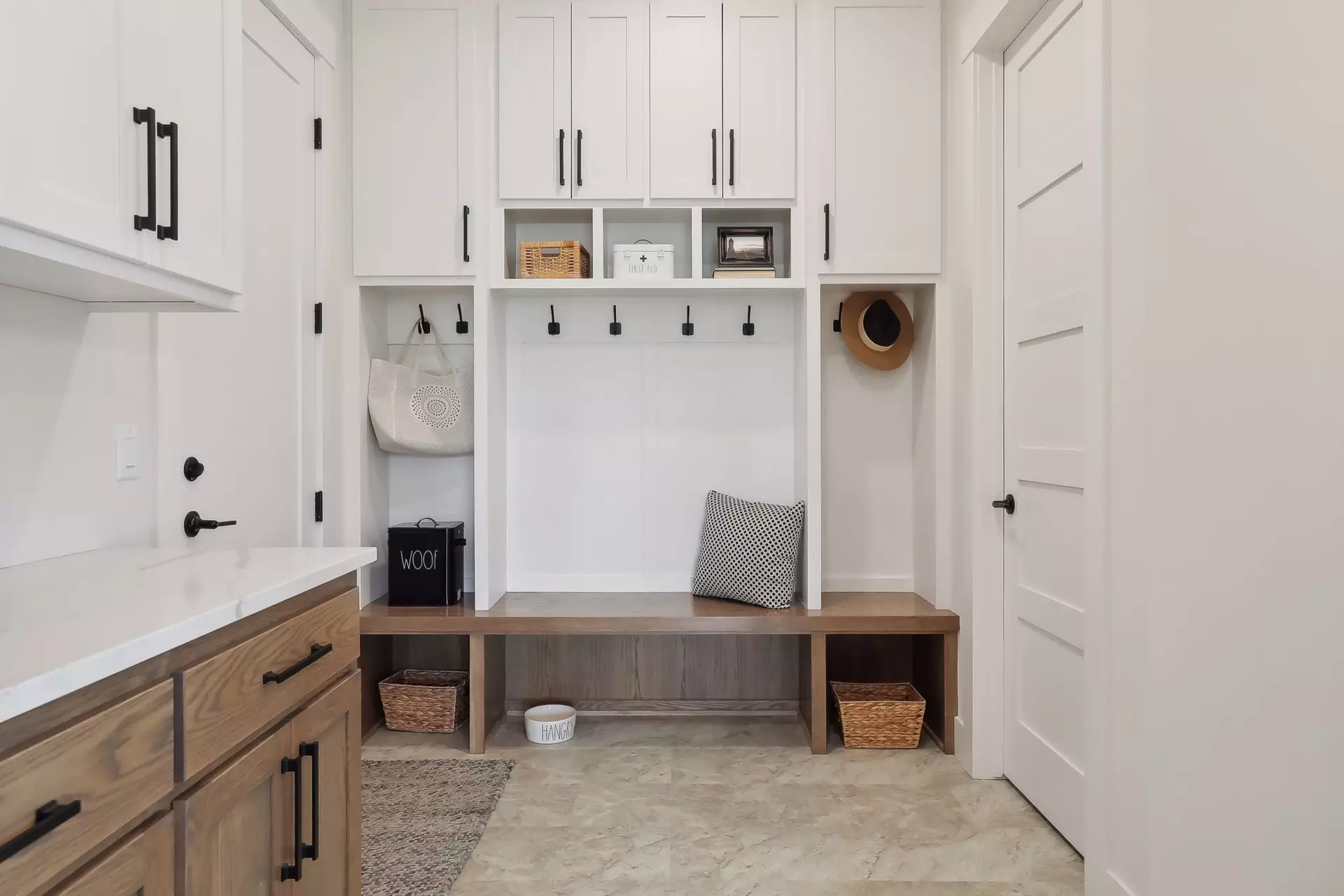 Mudroom has built-in bench and storage cabinets plus a walkin closet