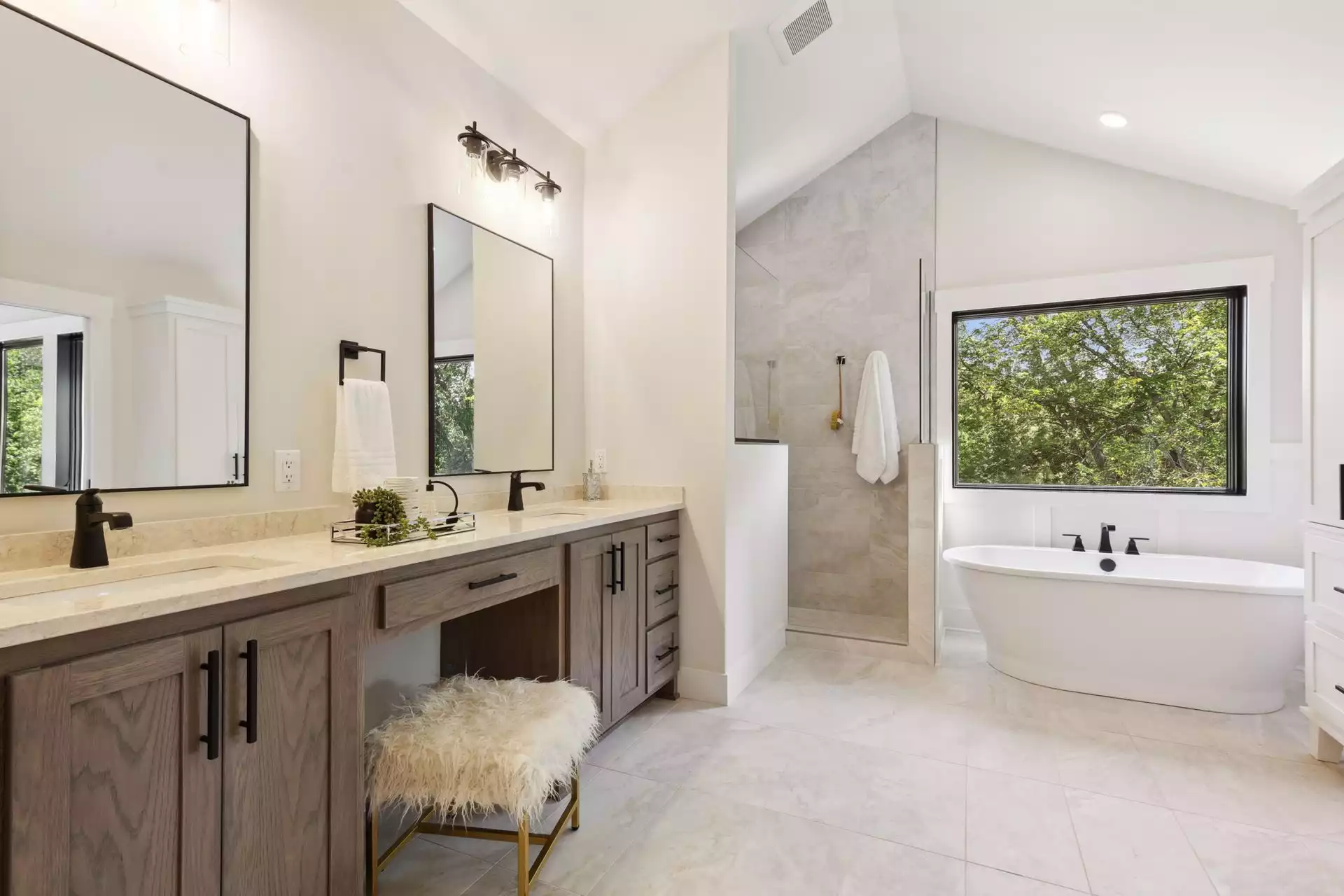 Owner’s suite bathroom features free standing soaking tub with a view